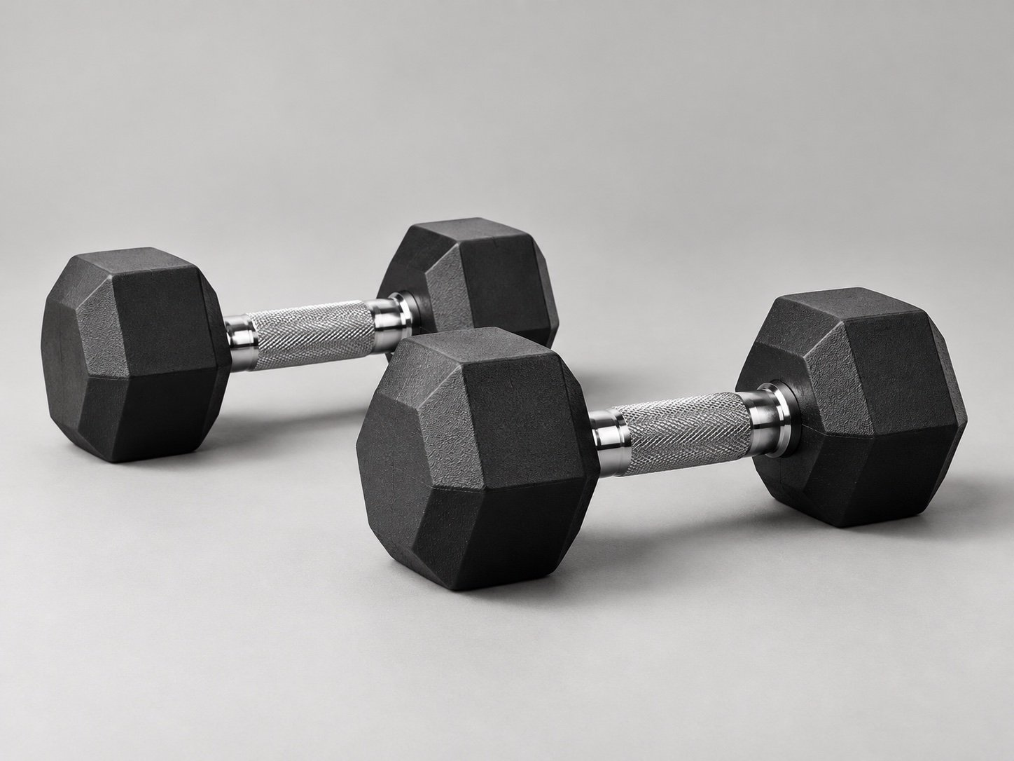 Illustrative black hex dumbbells with chrome handles
